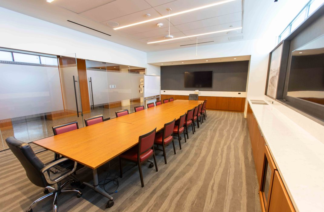 conference table with chairs and TV on wall